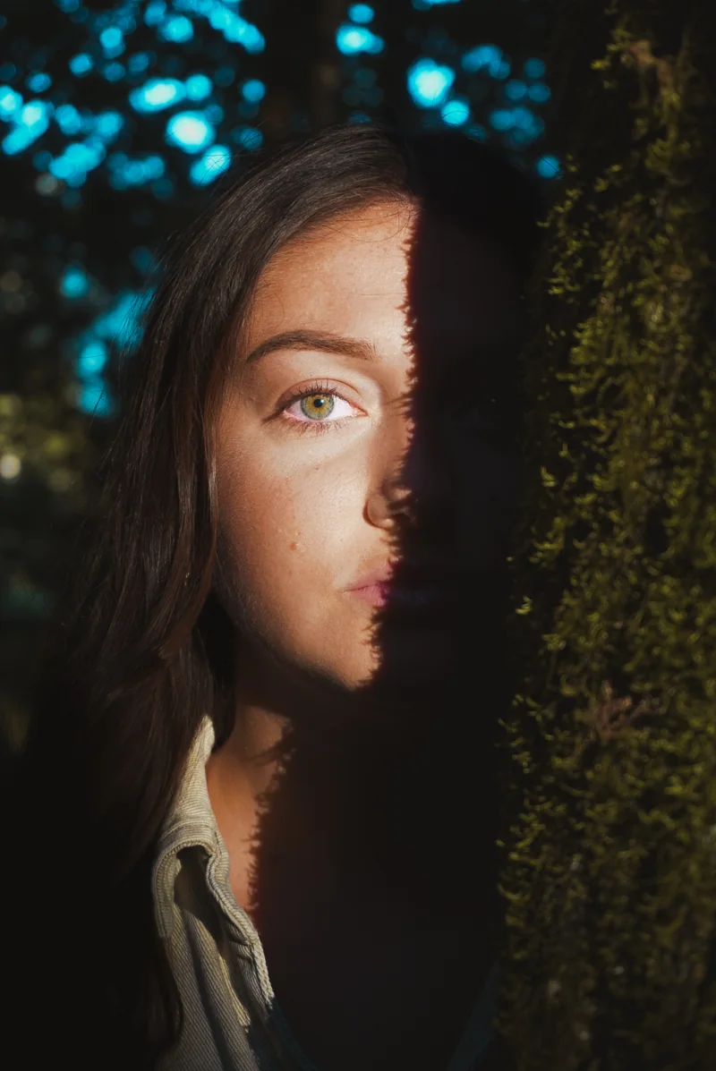 Une bande de lumière éclaire l’œil et la joue d’une femme